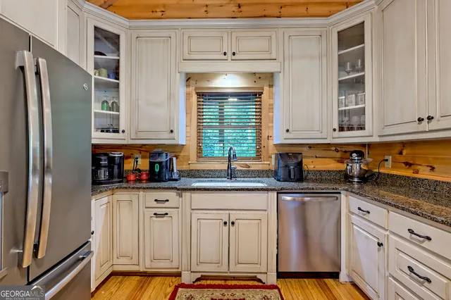 a kitchen with granite countertop a cabinets and window