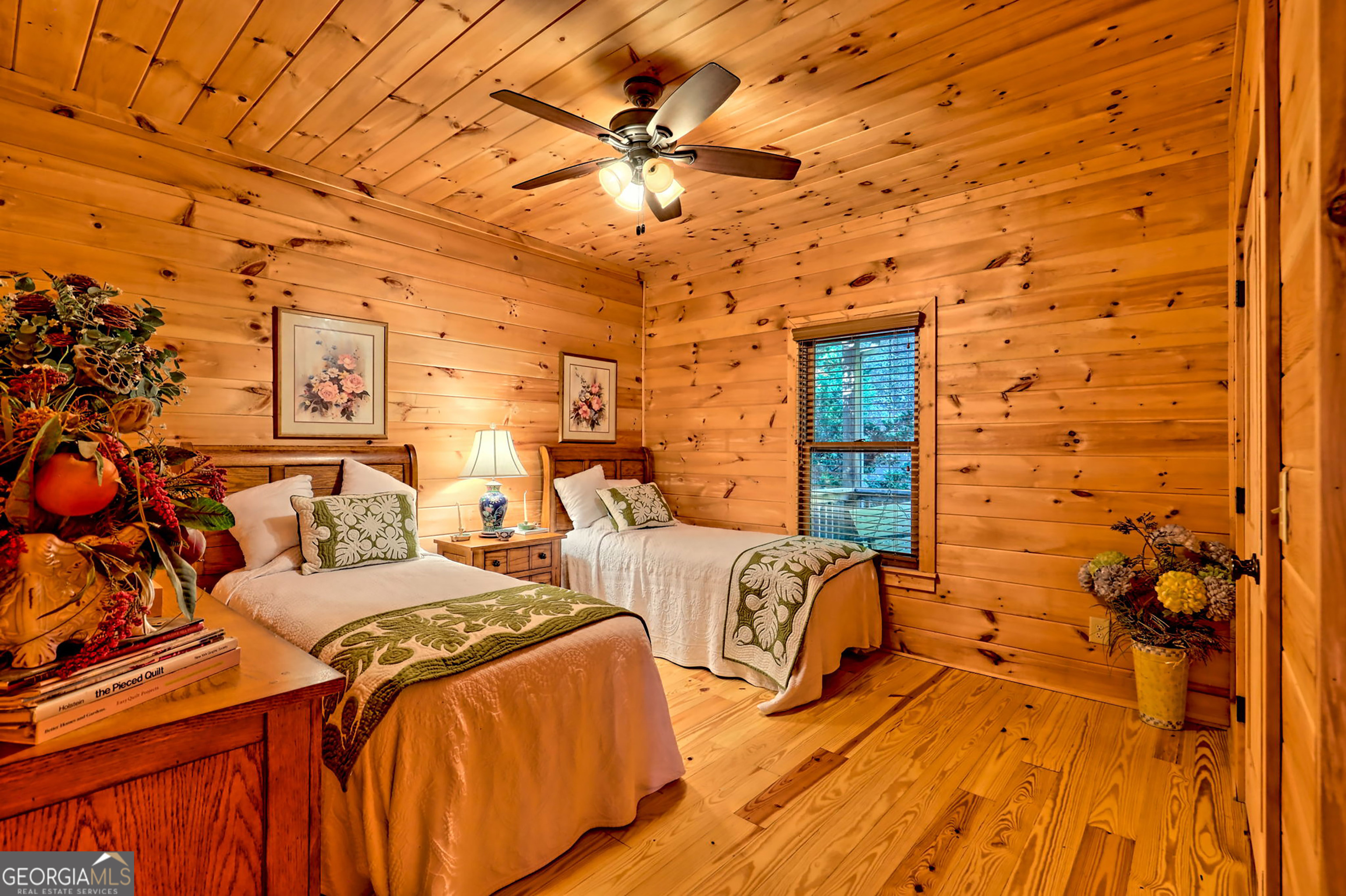 407 Blackberry Drive Rabun Gap, GA 30568 - Photo 29 of 53 a bedroom with a bed and a lamp on the wall