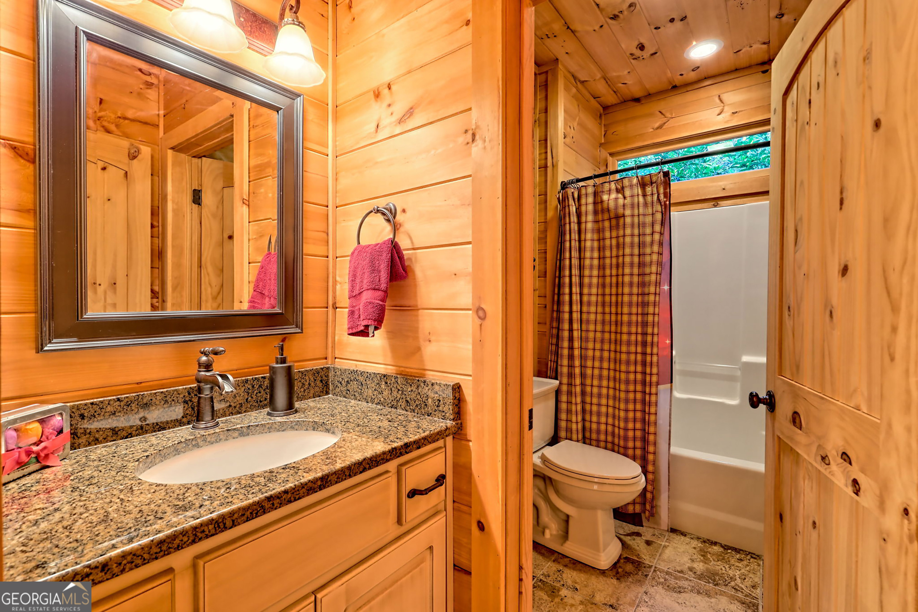 407 Blackberry Drive Rabun Gap, GA 30568 - Photo 30 of 53 a bathroom with a granite countertop sink toilet and shower