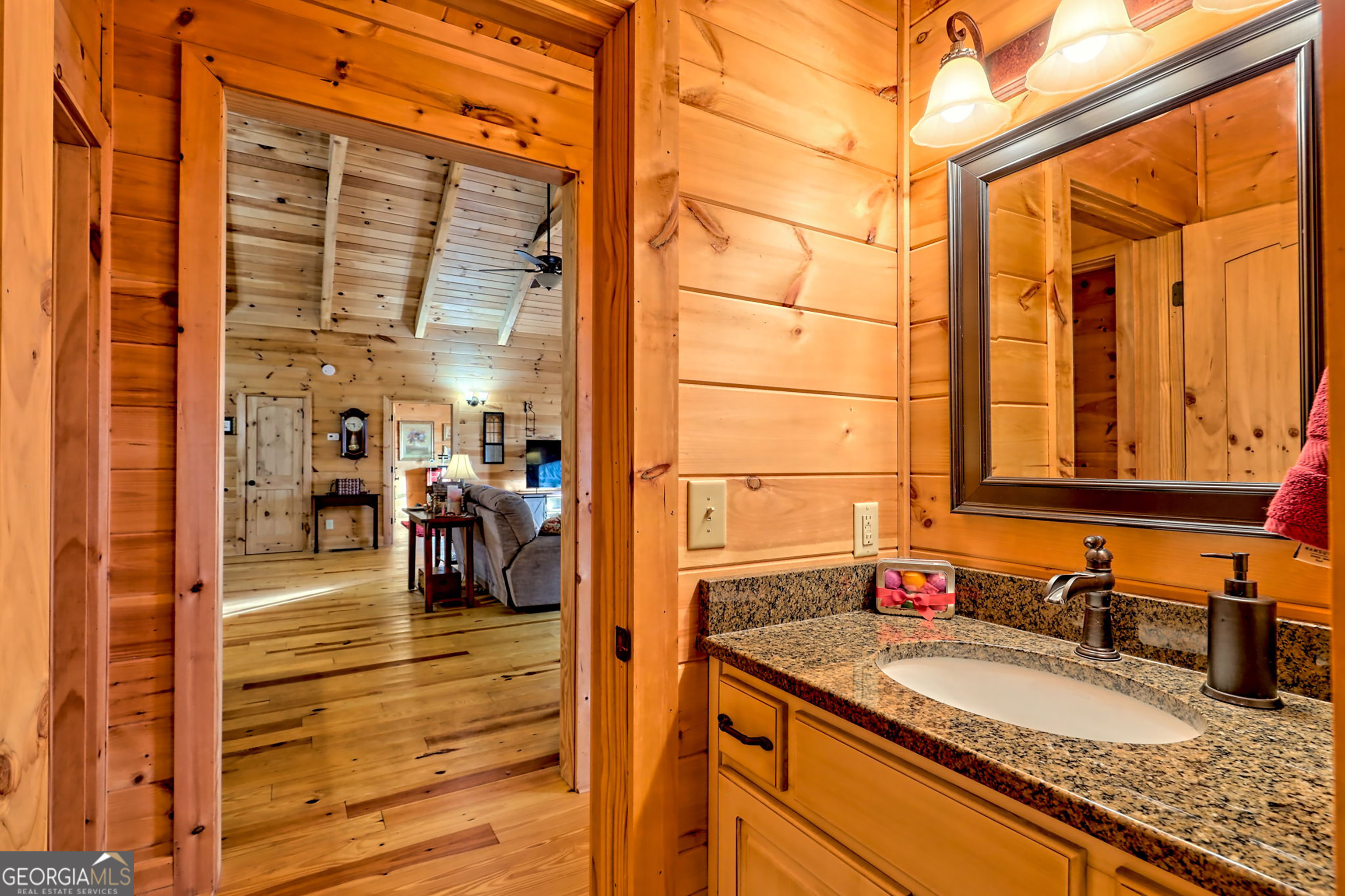 407 Blackberry Drive Rabun Gap, GA 30568 - Photo 32 of 53 a bathroom with a granite countertop sink and a mirror