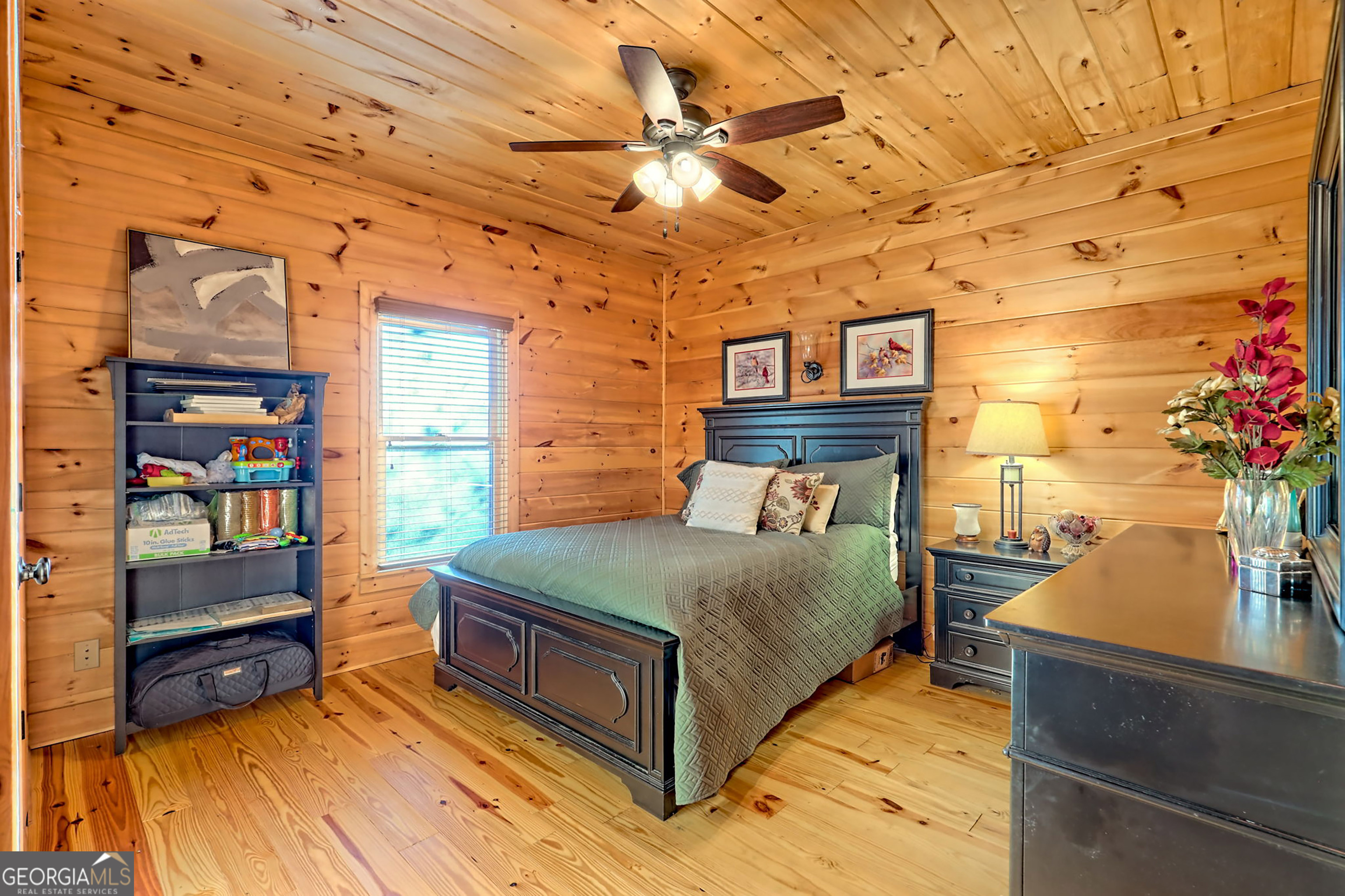 407 Blackberry Drive Rabun Gap, GA 30568 - Photo 33 of 53 a bedroom with a bed and a potted plant on the dresser