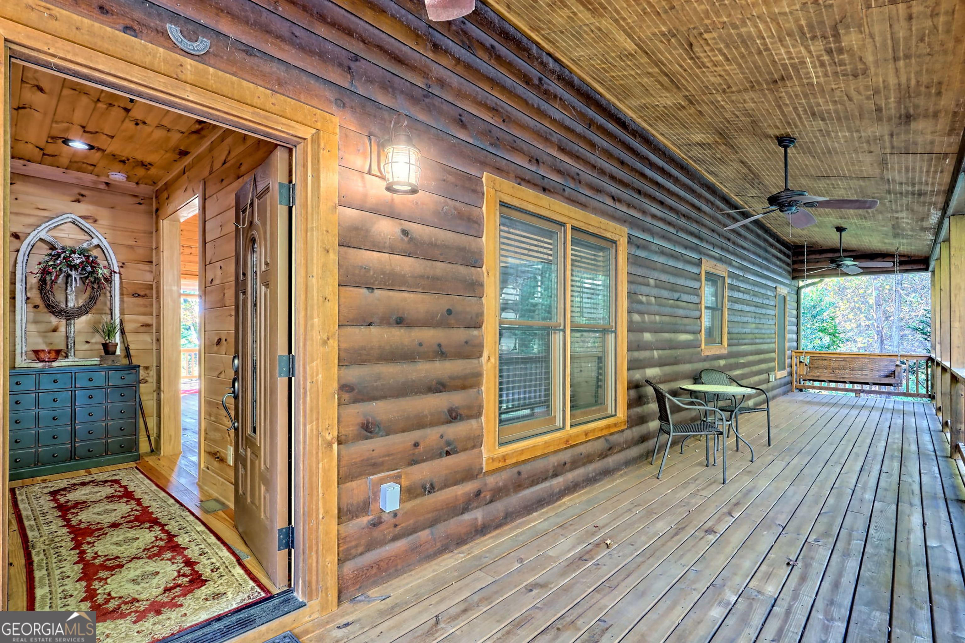 407 Blackberry Drive Rabun Gap, GA 30568 - Photo 7 of 53 a view of a patio with table and chairs and wooden floor
