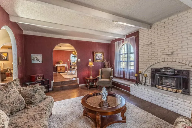 a living room with furniture a fireplace and window