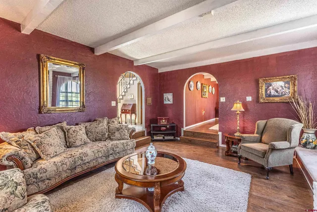 a living room with furniture a rug and a window