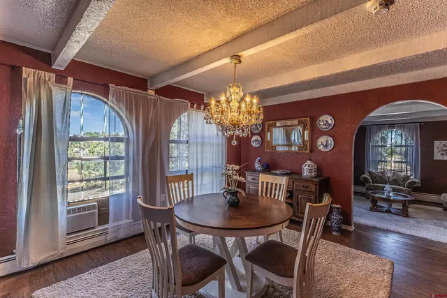 a view of a dining room with furniture window and wooden floor