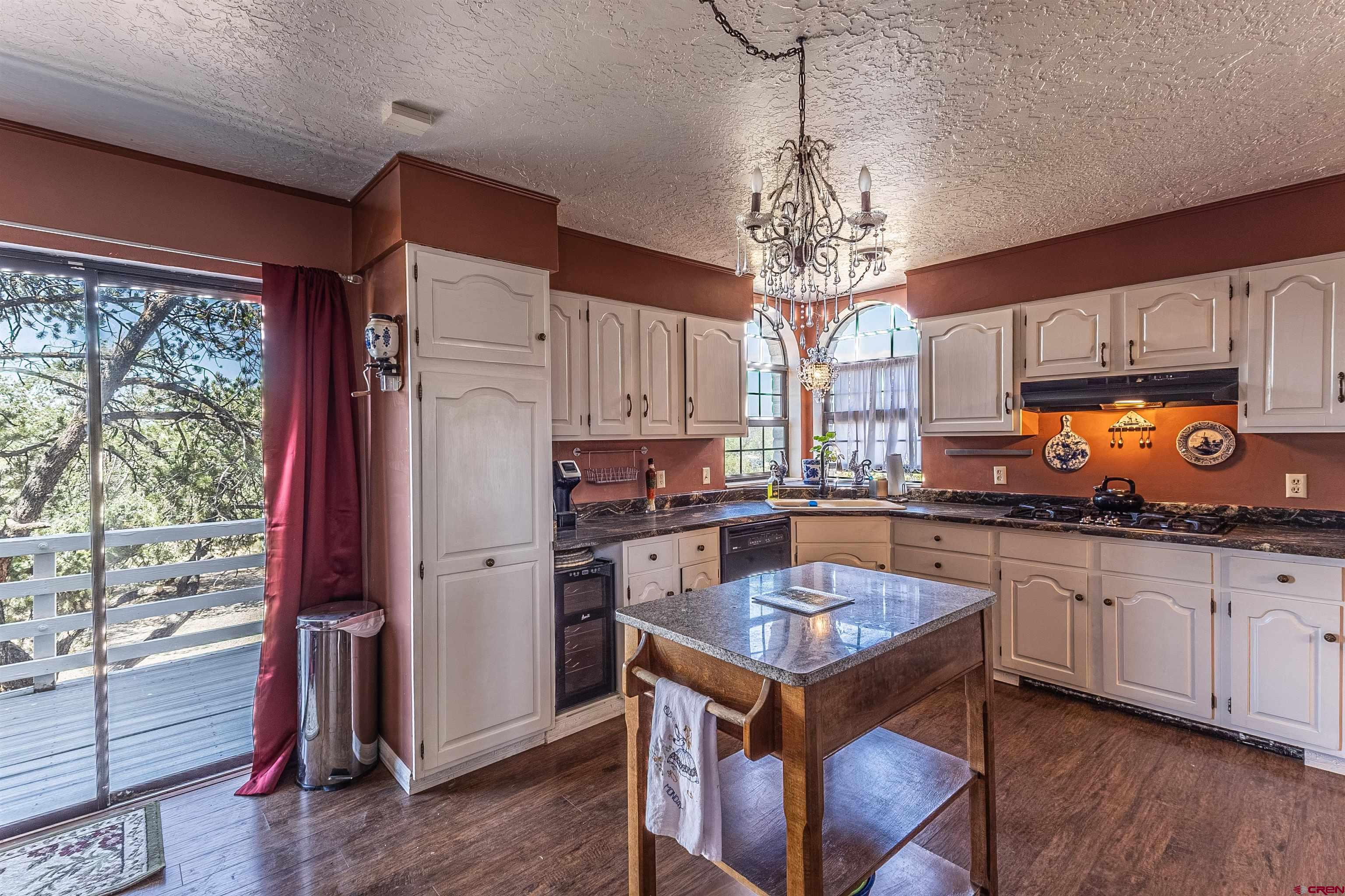 5510 Rinconada Street Farmington, NM 87402 - Photo 20 of 45 a kitchen with a refrigerator a stove a sink dishwasher with a dining table and chairs