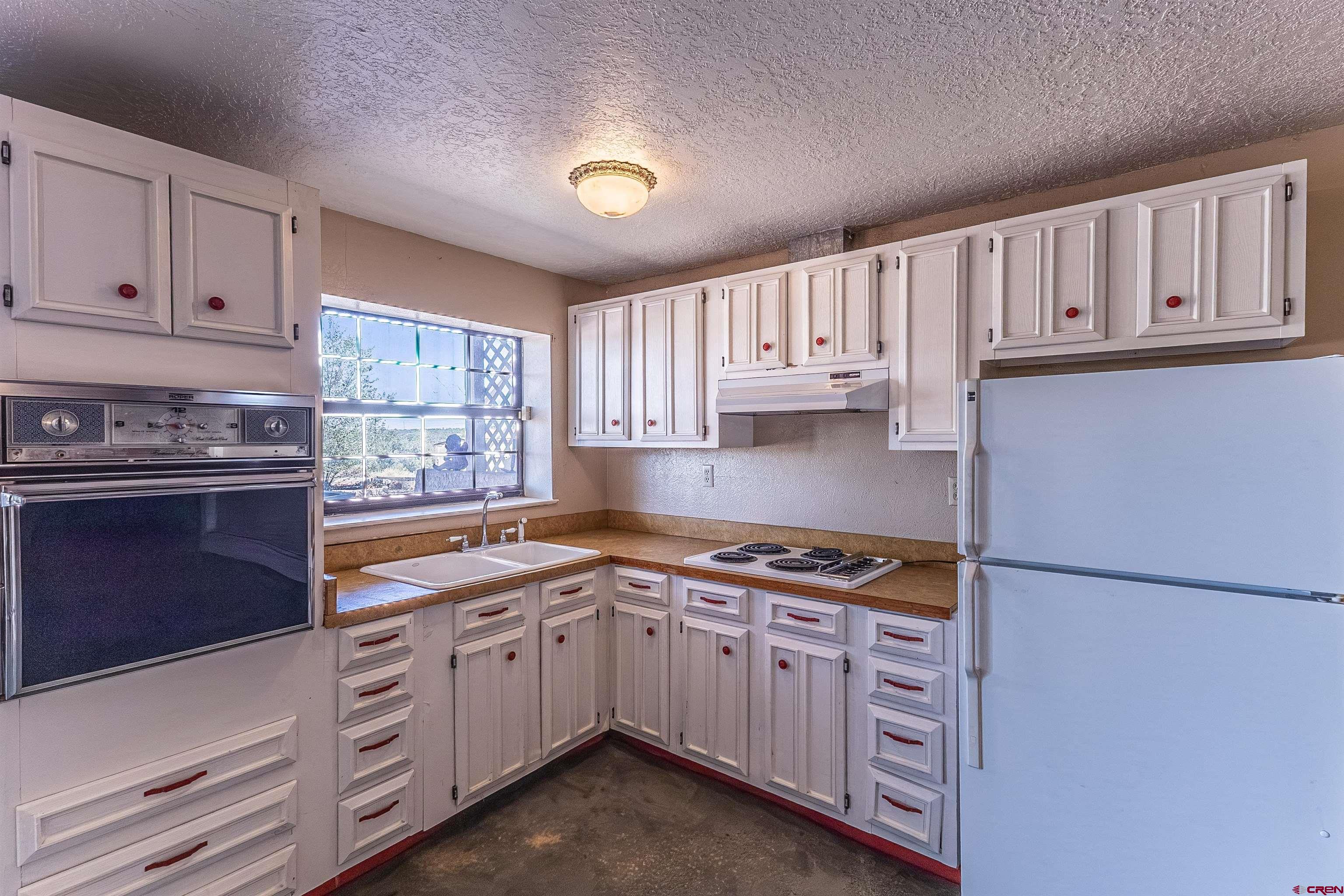5510 Rinconada Street Farmington, NM 87402 - Photo 33 of 45 a kitchen with cabinets appliances a sink and a window