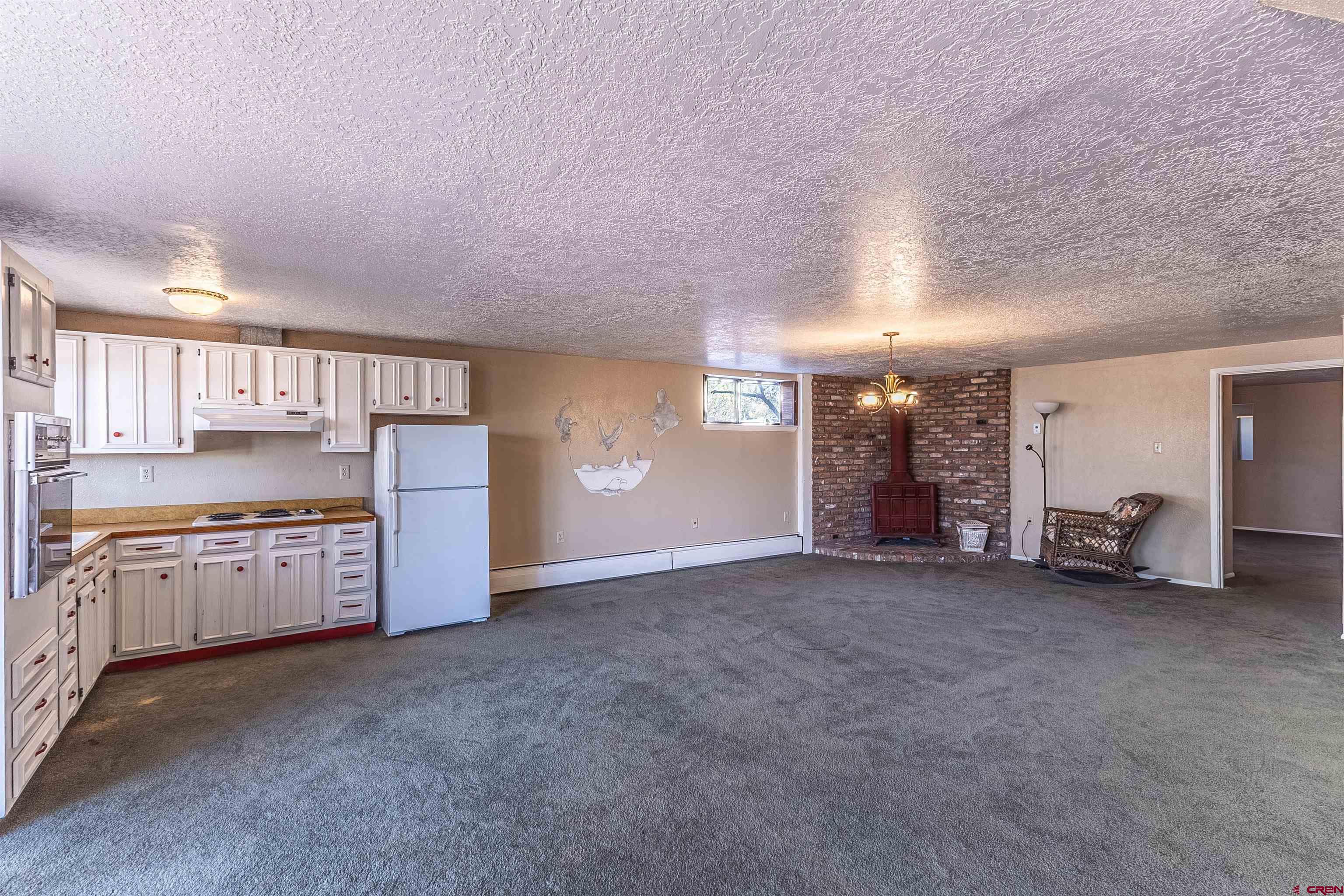 5510 Rinconada Street Farmington, NM 87402 - Photo 34 of 45 a large kitchen with cabinets and a stove