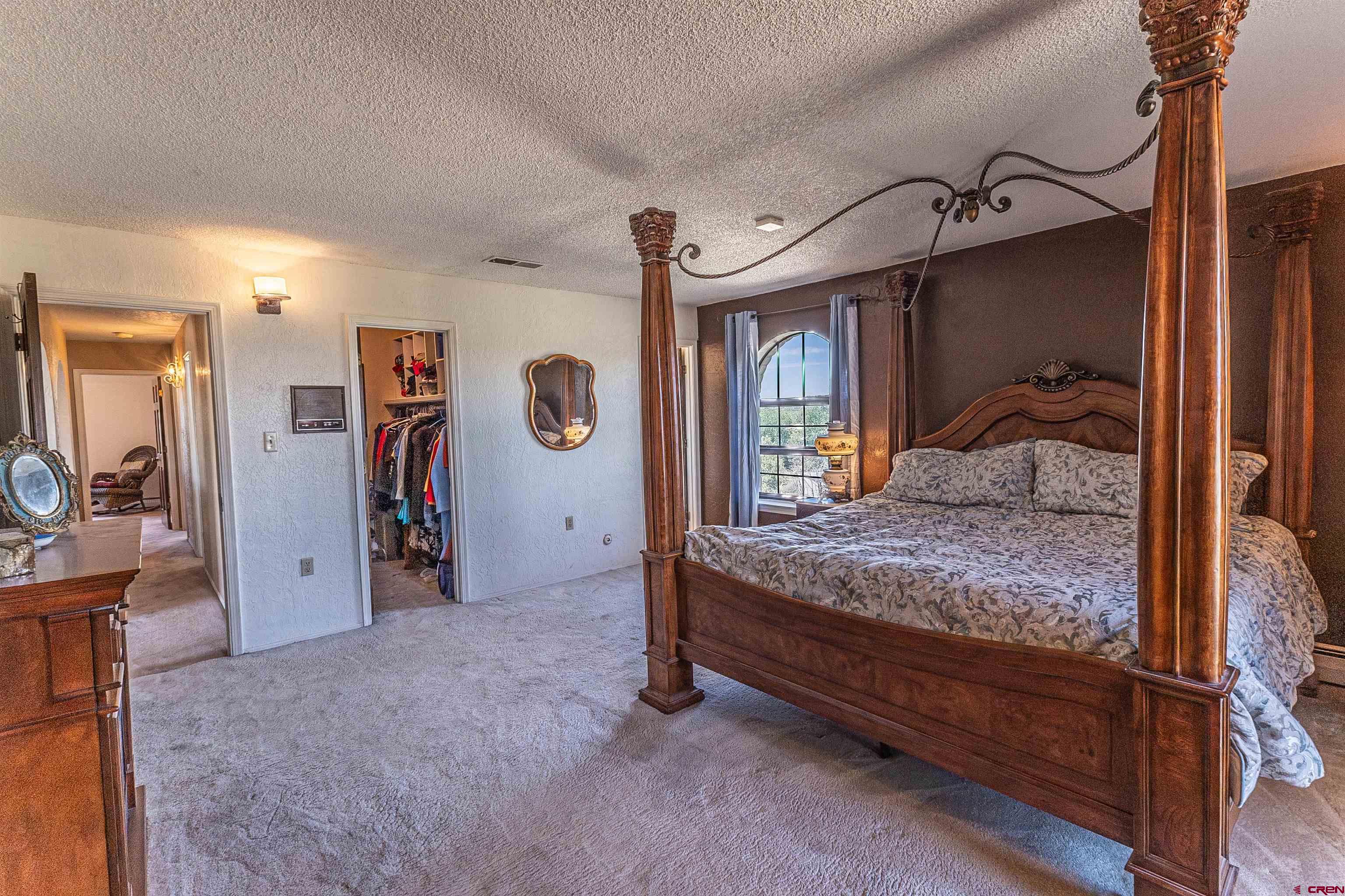 5510 Rinconada Street Farmington, NM 87402 - Photo 37 of 45 a bedroom with a bed and a mirror on the dresser