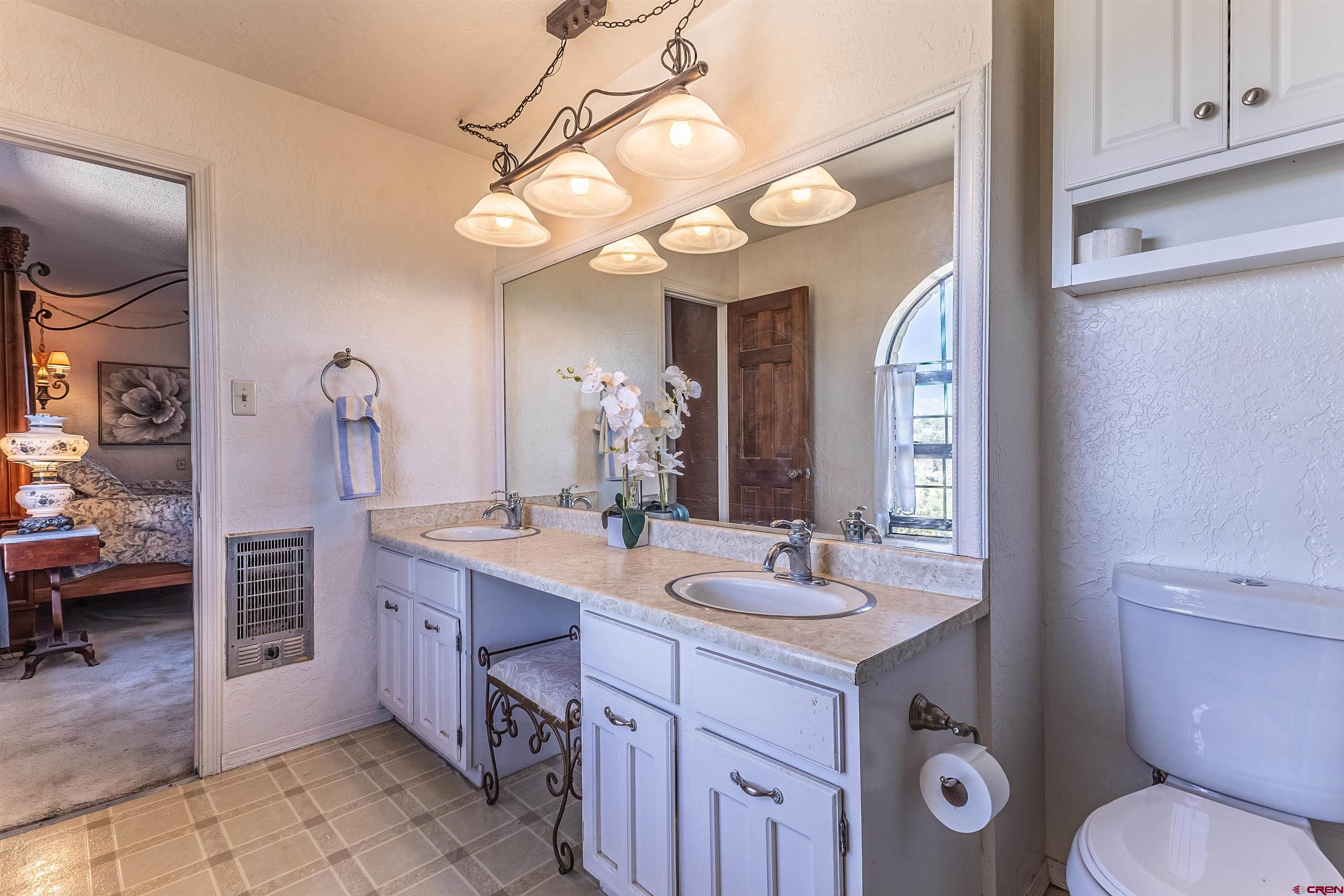 5510 Rinconada Street Farmington, NM 87402 - Photo 39 of 45 a bathroom with a sink a light fixture and a toilet