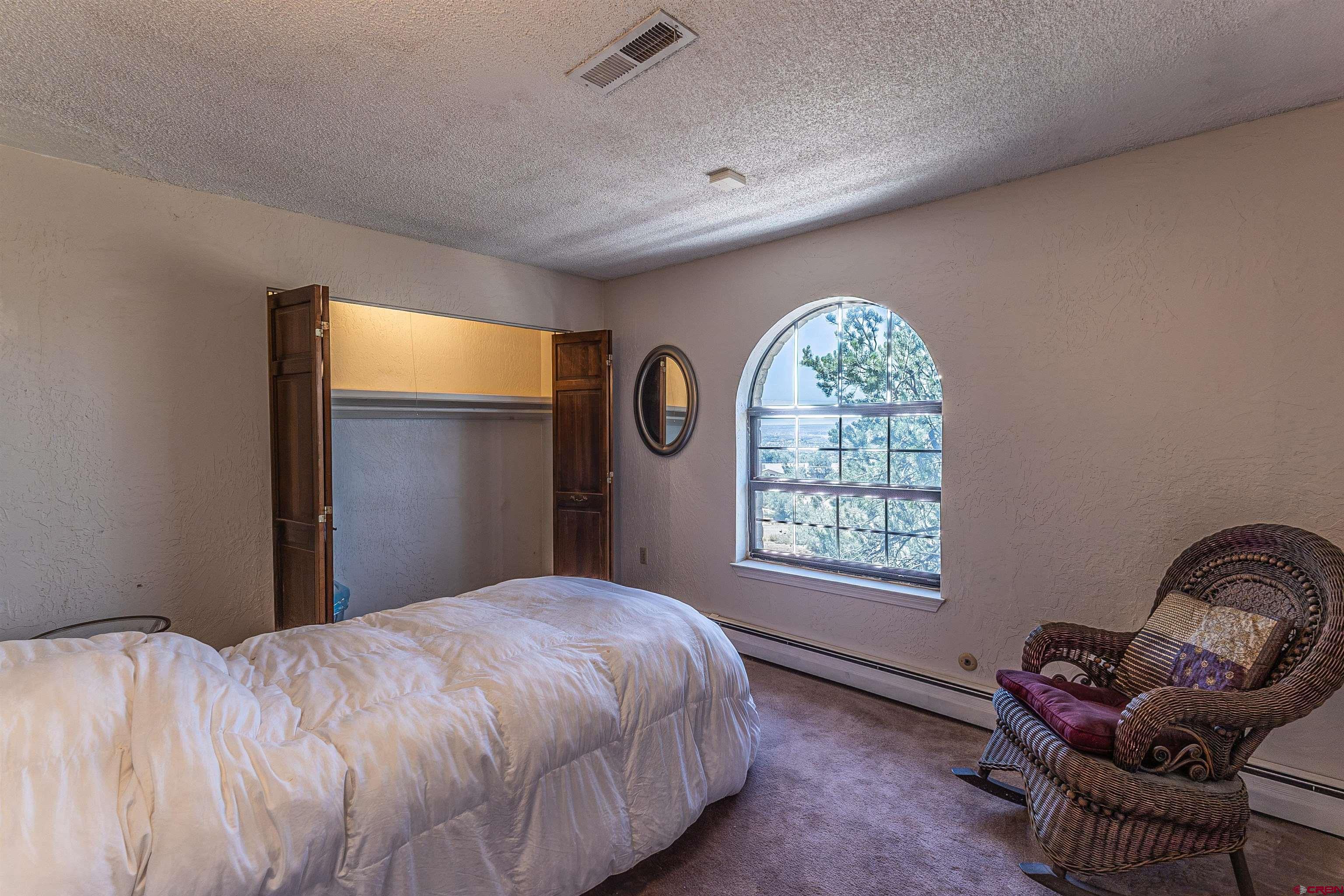 5510 Rinconada Street Farmington, NM 87402 - Photo 44 of 45 a bedroom with a bed and a window