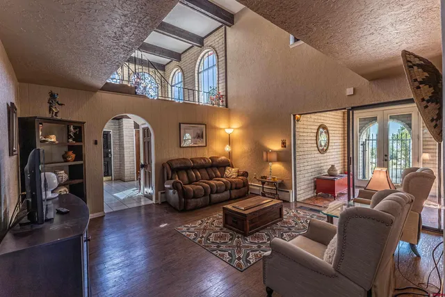 a living room with furniture fireplace and a large window