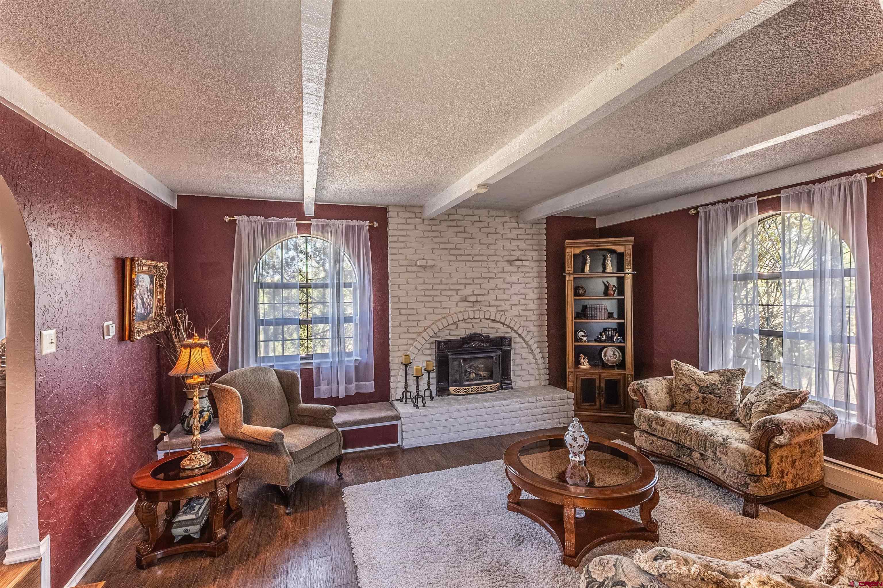5510 Rinconada Street Farmington, NM 87402 - Photo 10 of 45 a living room with furniture fireplace and a large window