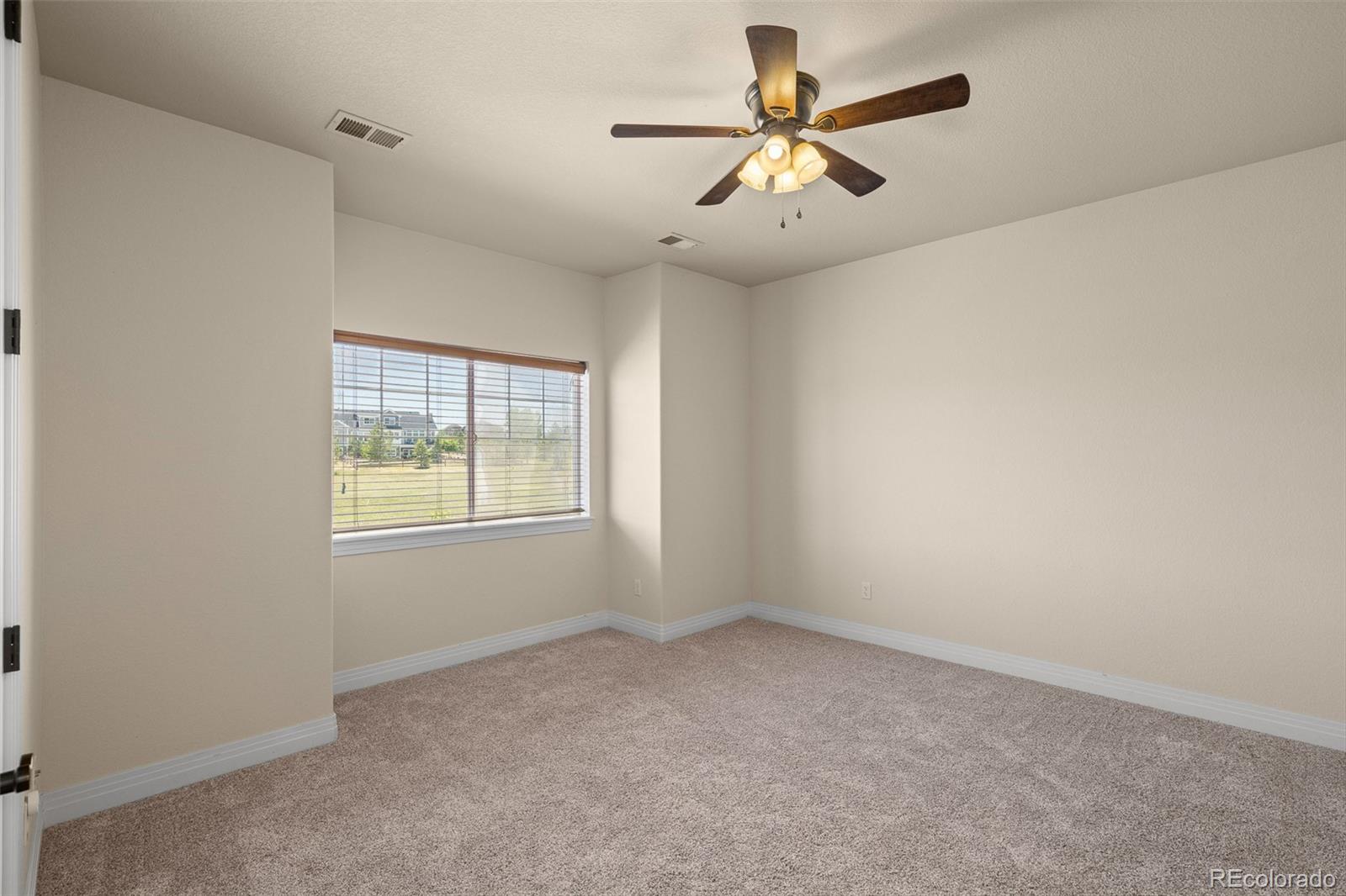 41865 East Muirfield Loop Elizabeth, CO 80107 - Photo 24 of 50 an empty room with a window and a fan