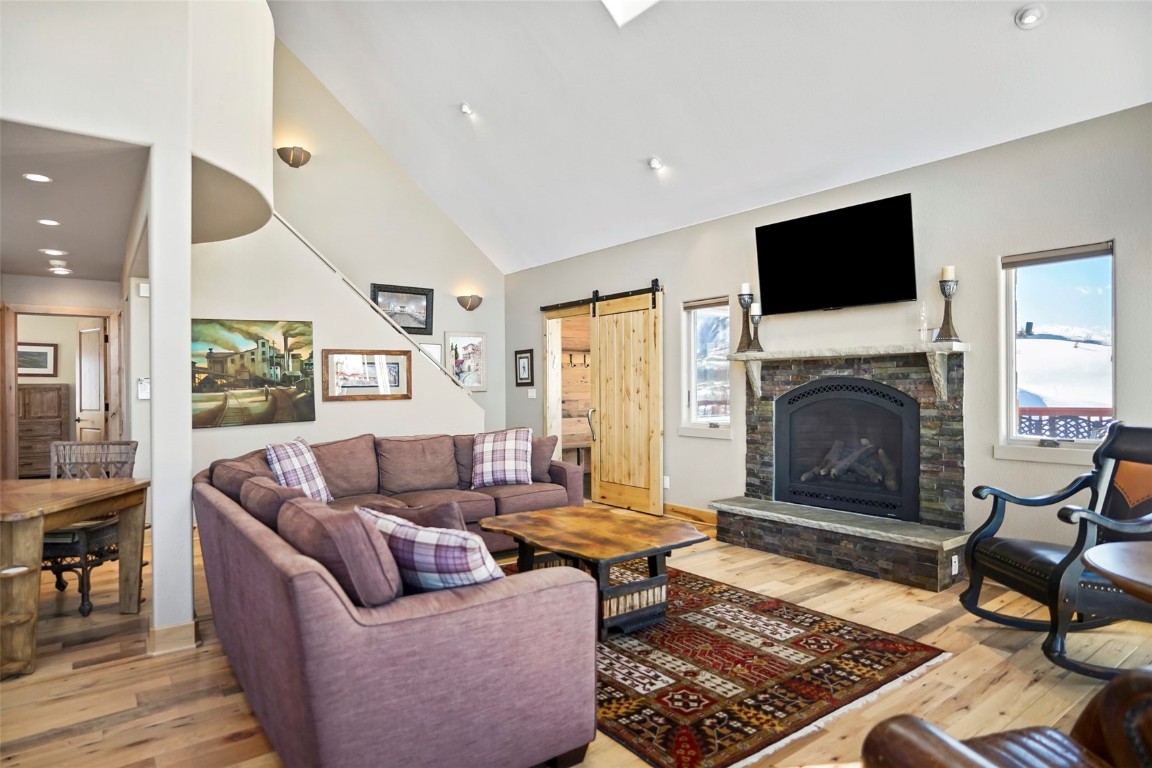 468 South Hillside Drive Silverthorne, CO 80498 - Photo 12 of 34 a living room with furniture flat screen tv and a fireplace