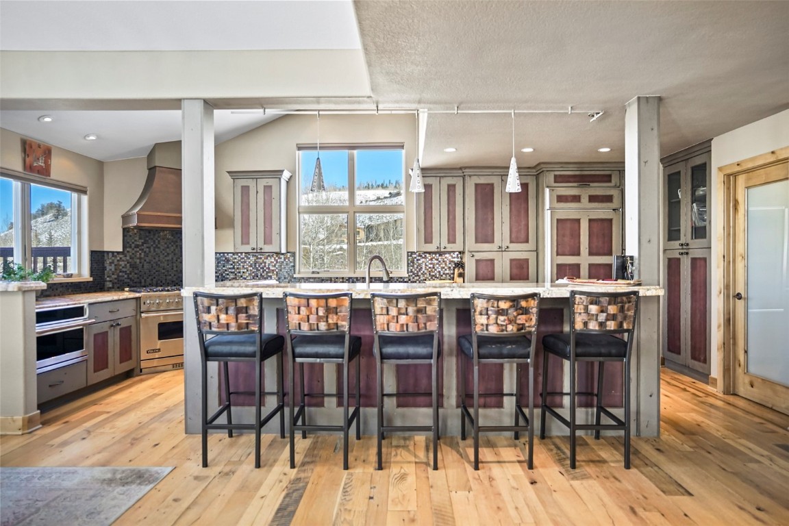 468 South Hillside Drive Silverthorne, CO 80498 - Photo 16 of 34 a dining room with stainless steel appliances granite countertop a table and chairs a refrigerator with wooden floor
