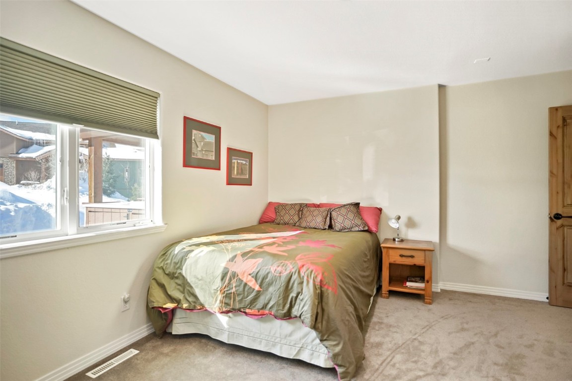468 South Hillside Drive Silverthorne, CO 80498 - Photo 19 of 34 a bedroom with a bed and a cabinets