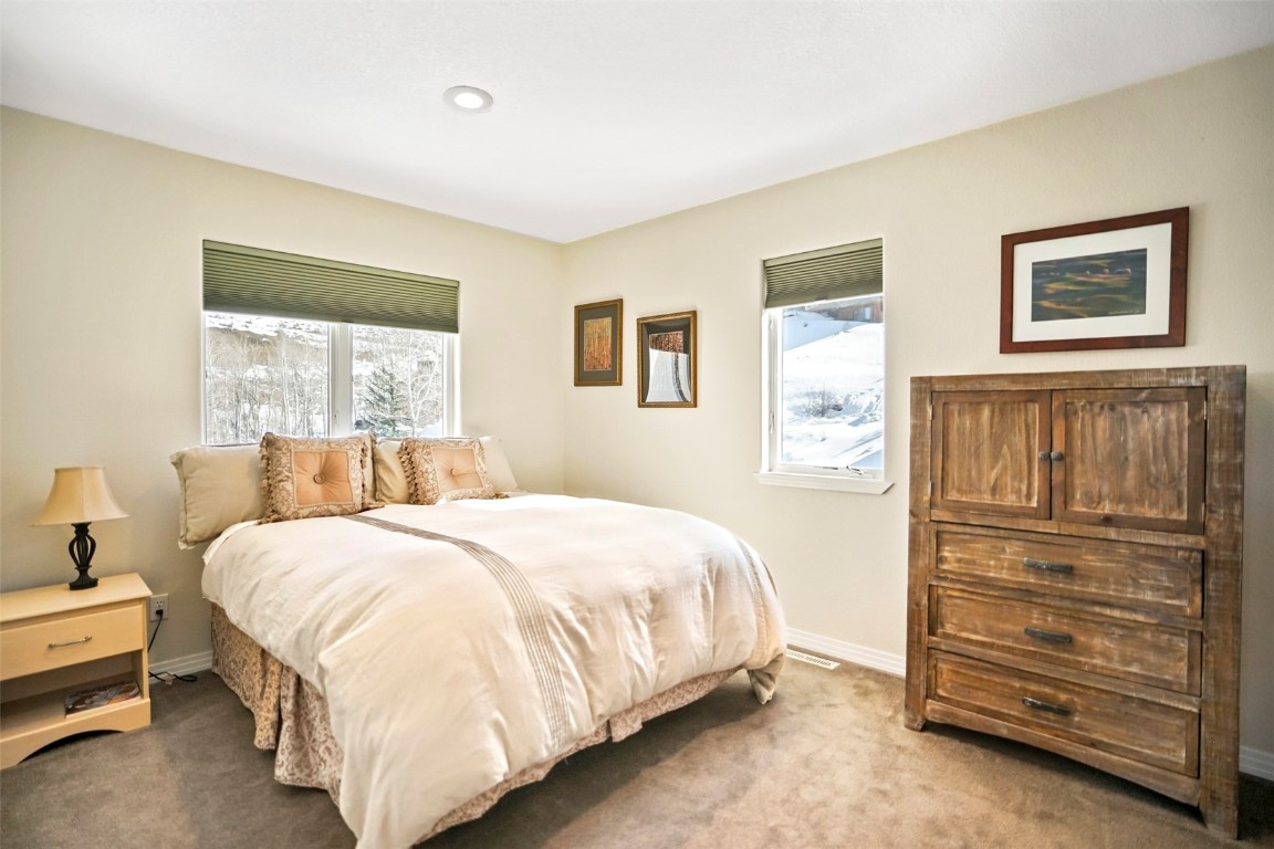 468 South Hillside Drive Silverthorne, CO 80498 - Photo 20 of 34 a bedroom with a bed and a window