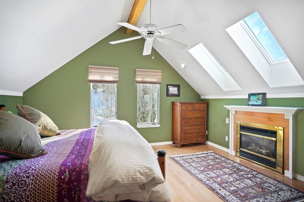 468 South Hillside Drive Silverthorne, CO 80498 - Photo 23 of 34 a spacious bedroom with a bed and a fireplace