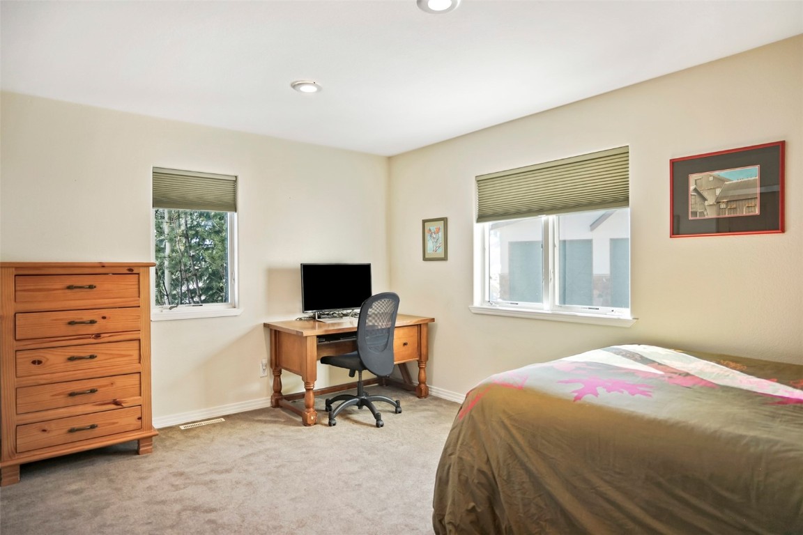 468 South Hillside Drive Silverthorne, CO 80498 - Photo 25 of 34 a bedroom with a bed and a window