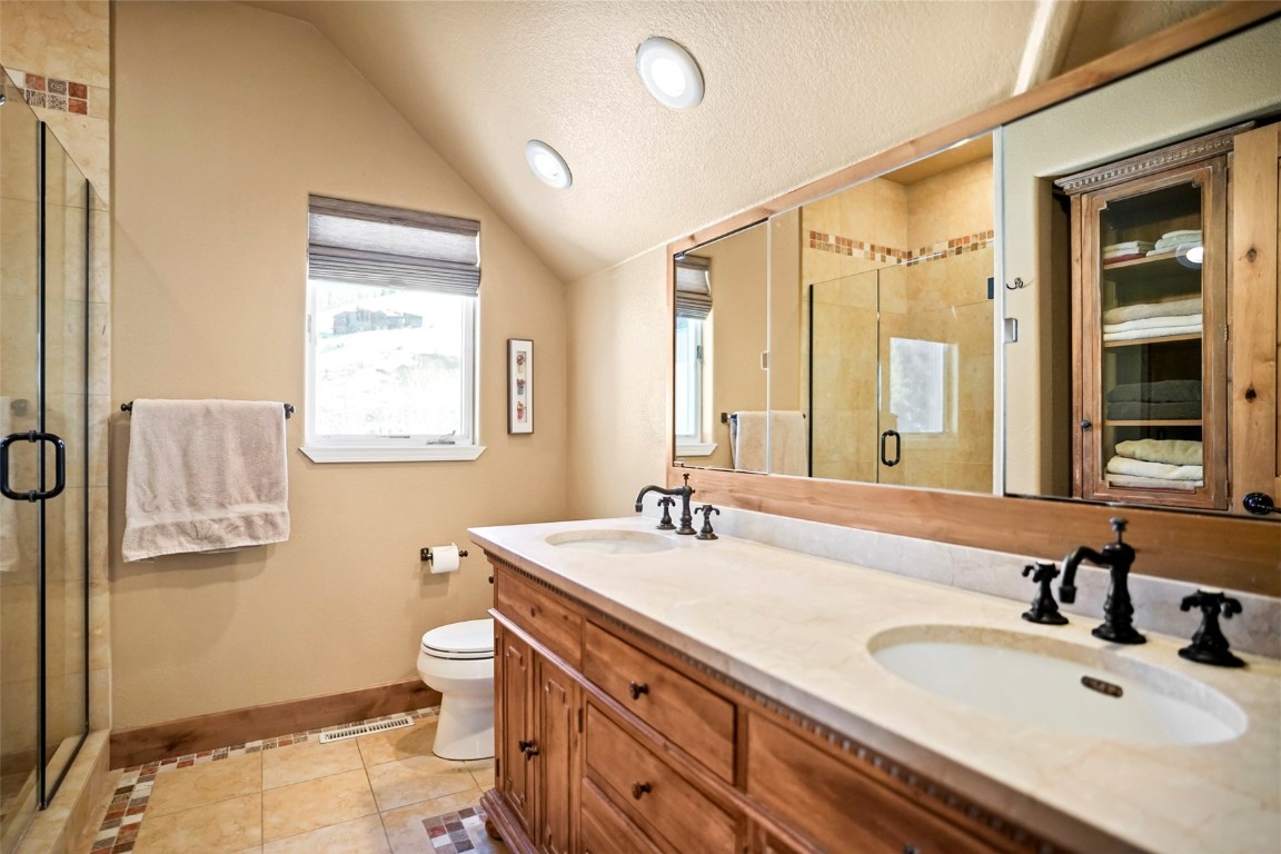 468 South Hillside Drive Silverthorne, CO 80498 - Photo 26 of 34 a bathroom with a double vanity sink toilet and a mirror