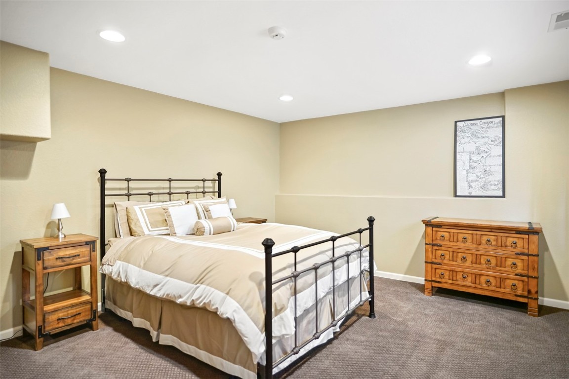 468 South Hillside Drive Silverthorne, CO 80498 - Photo 28 of 34 a bedroom with a bed and a night stand