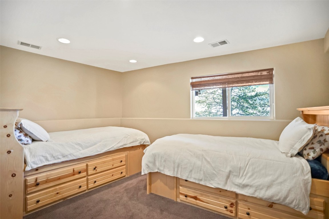 468 South Hillside Drive Silverthorne, CO 80498 - Photo 31 of 34 a bedroom with a bed and a window