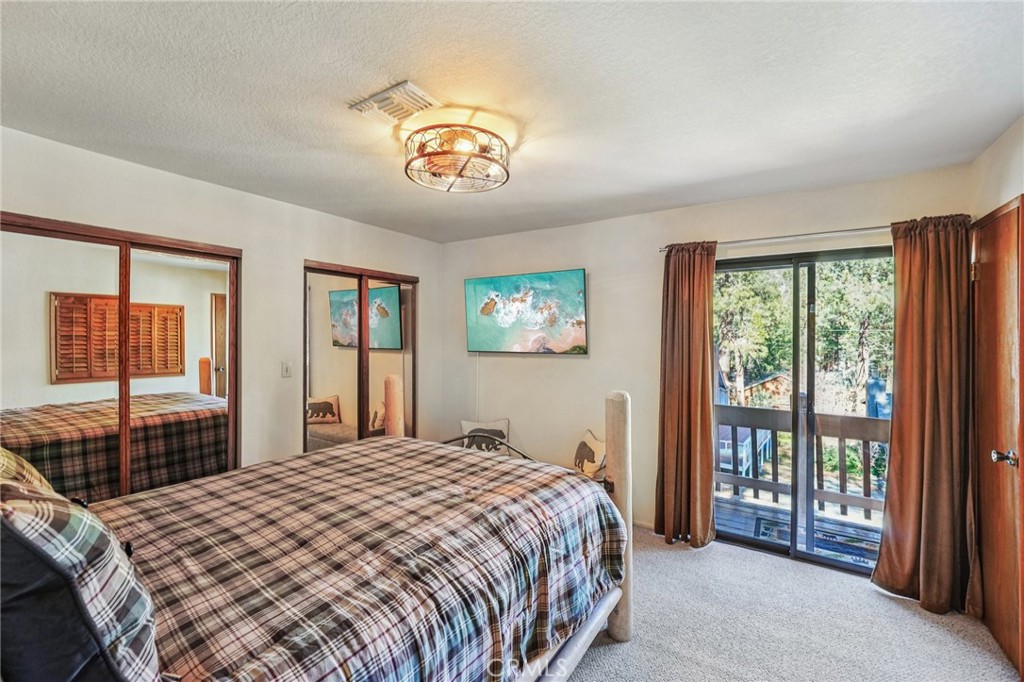 1847 Thrush Road Wrightwood, CA 92397 - Photo 10 of 33 a bedroom with a large bed and a large window