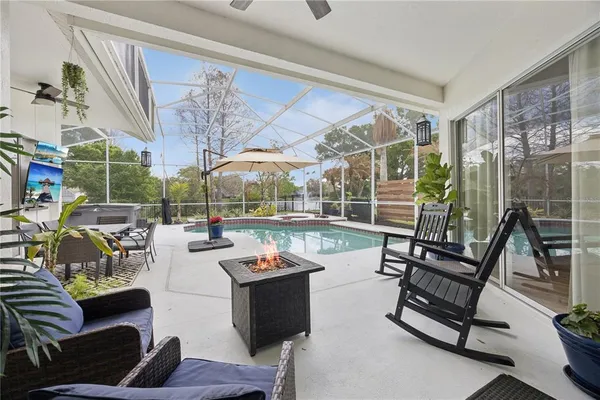 a living room with furniture and a floor to ceiling window