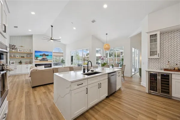 a large kitchen with stainless steel appliances kitchen island granite countertop a lot of counter space and wooden floors