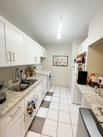 a kitchen with stainless steel appliances granite countertop a sink and cabinets