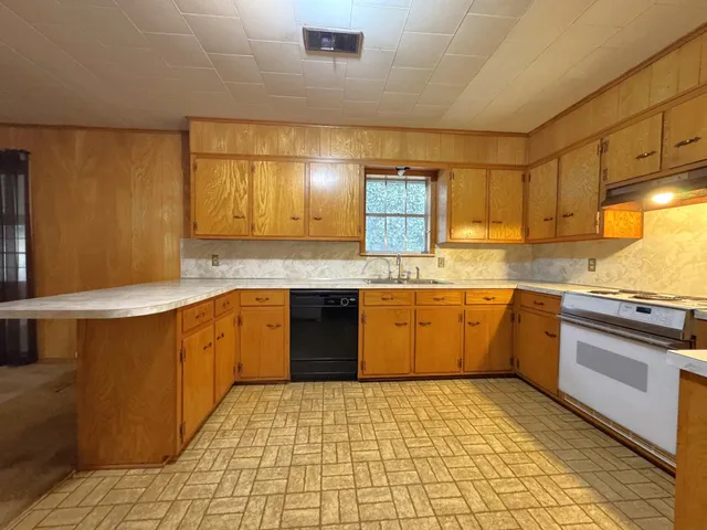 a bathroom with a granite countertop toilet and sink