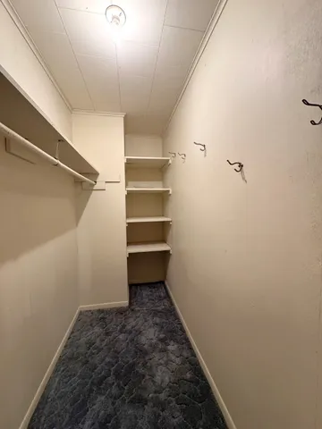 an empty room with closet area