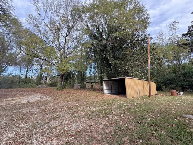 a house that has a tree in front of it