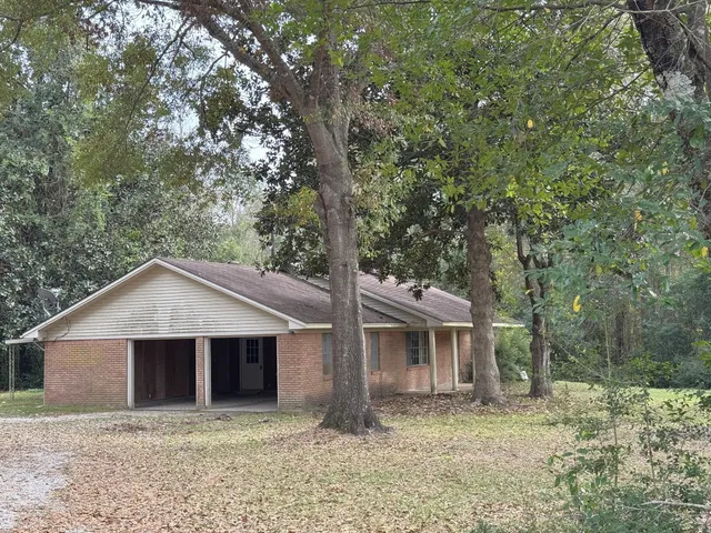 a view of a house with large trees