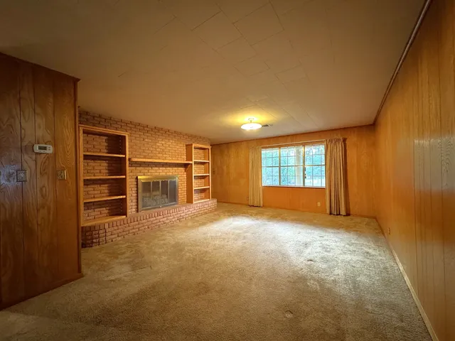a view of empty room with a fireplace and cabinet