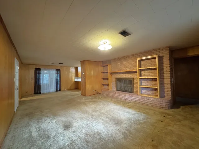 a view of an empty room with a kitchen