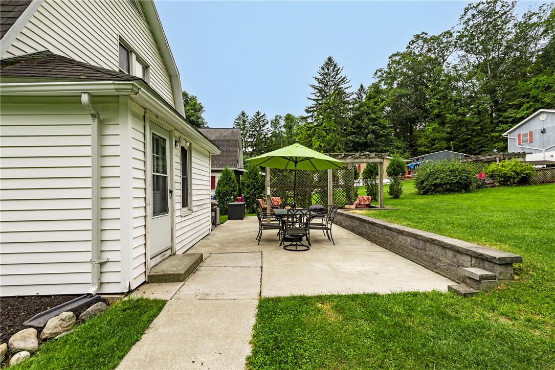 280 Oak Road Bangor, PA 18013 - Photo 4 of 52 Concrete patio spaces sit bordered by manicured lawn and a retaining wall.