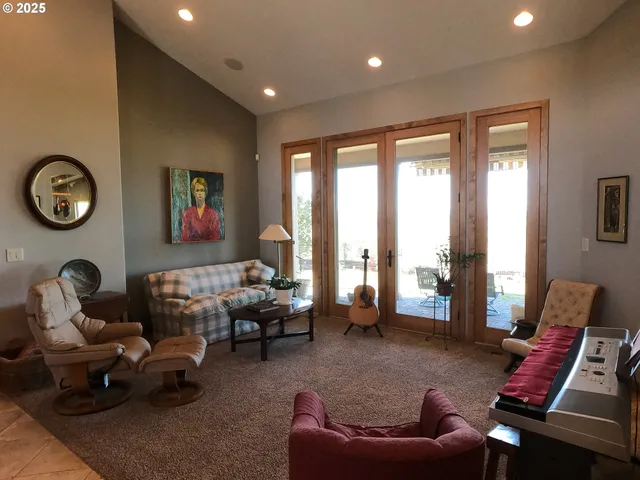 a living room with furniture and floor to ceiling window
