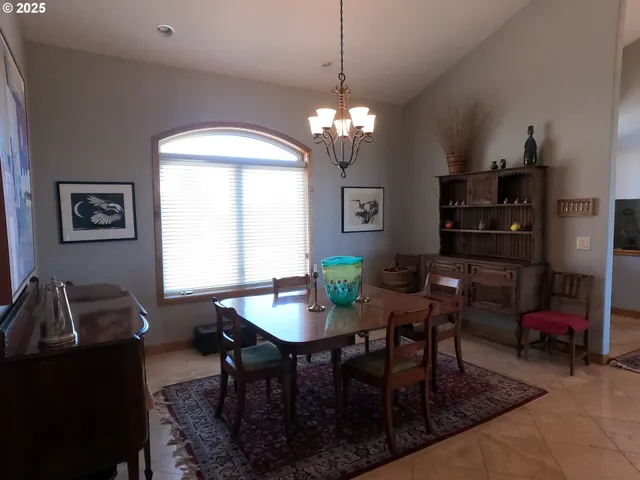 a view of a dining room with furniture and chandelier