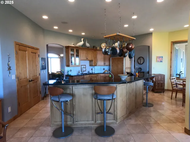 a kitchen with a dining table chairs and a chandelier
