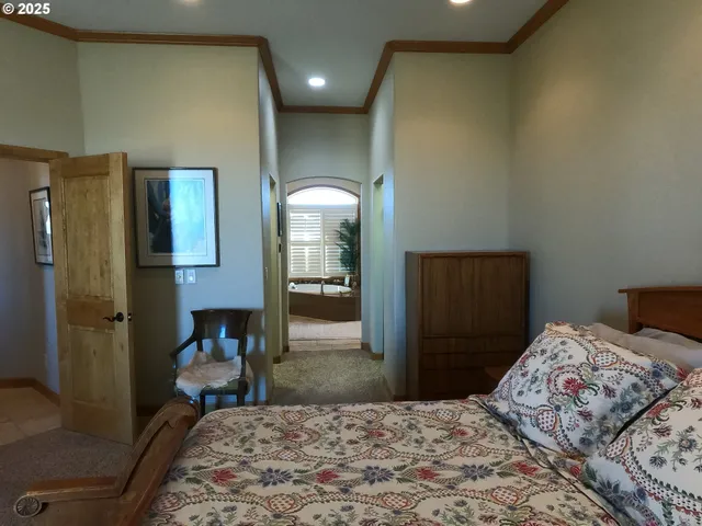 a bedroom with a bed and a dresser in it