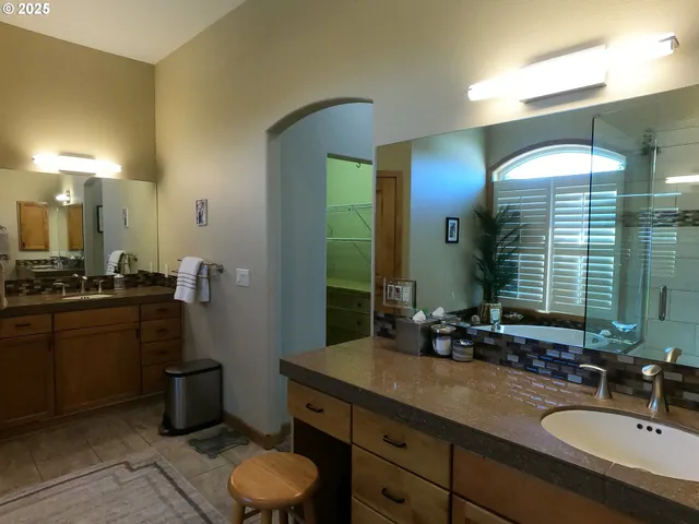 a bathroom with a sink mirror toilet and shower
