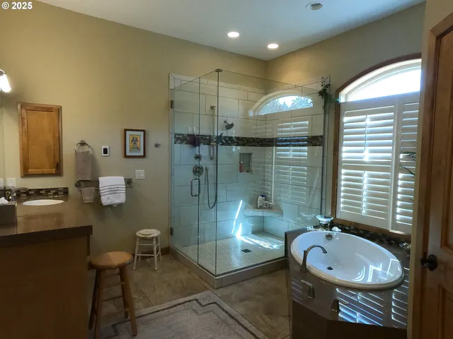 a white toilet sitting next to a bathroom sink and a window
