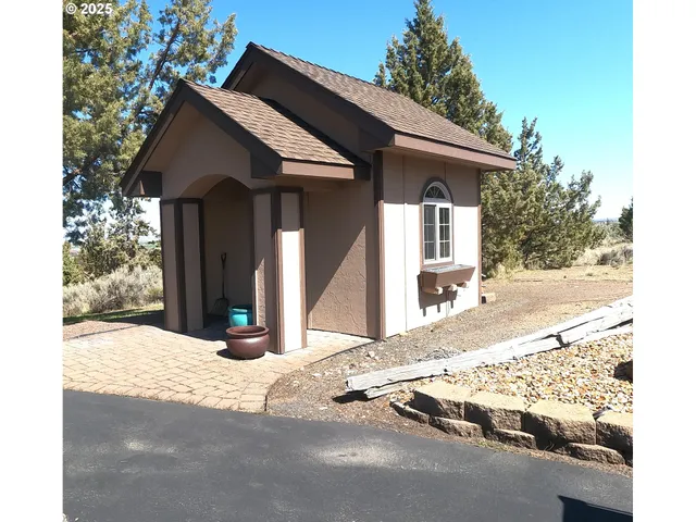 a view of a house with snow on the road