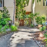 a view of a house with potted plants