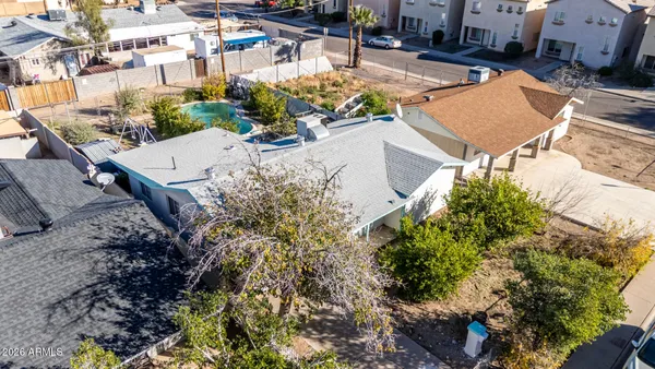 an aerial view of a house with a yard and lake view