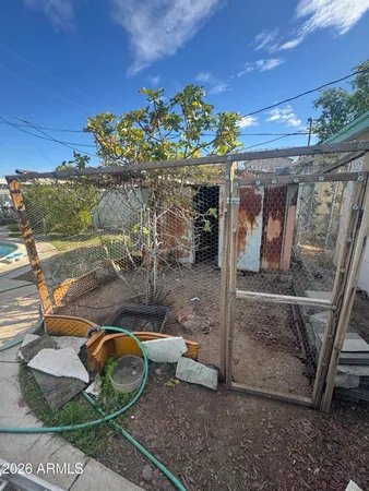 a backyard of a house with lots of furniture and a potted plant