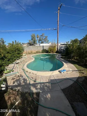 a view of a swimming pool with a yard