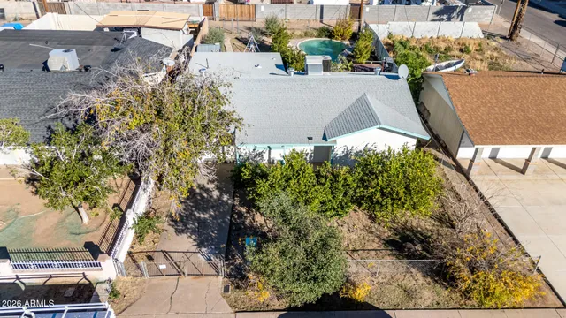 an aerial view of a house with a yard and trees
